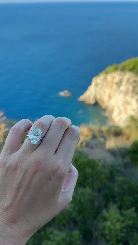 Vertical video hand with oval diamond ring above blue water Croatia Video stock 319456013