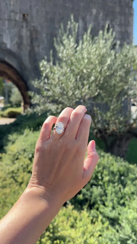 Vertical video hand with oval diamond ring near olive tree Croatia 스톡 동영상 319457028