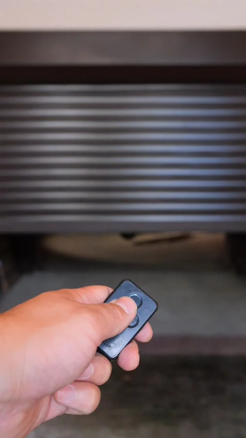 Vertical video hand pressing a remote control to open a garage door, revealing Stock Footage 340351675