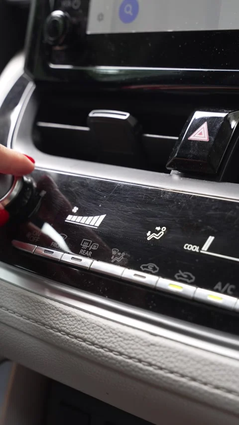 Vertical video of a hand reducing AC power in car Stock Footage 345011578