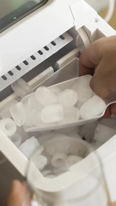 Vertical video of hand taking ice cubes from ice maker Stock Footage 342239809