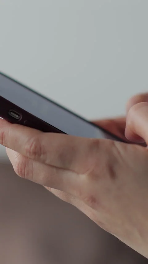 Vertical video Hand of woman using texting mobile phone or chat. Stock Footage 337650971