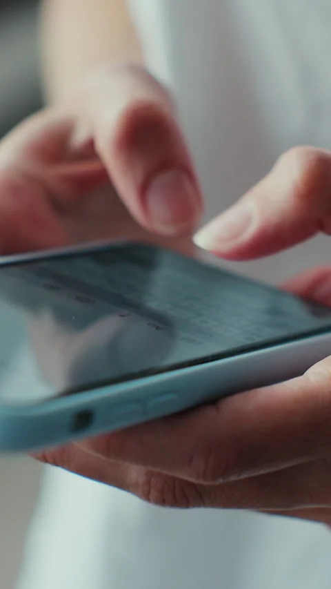 Vertical video. Hand of woman using texting mobile phone or chat. Stock Footage 345056333