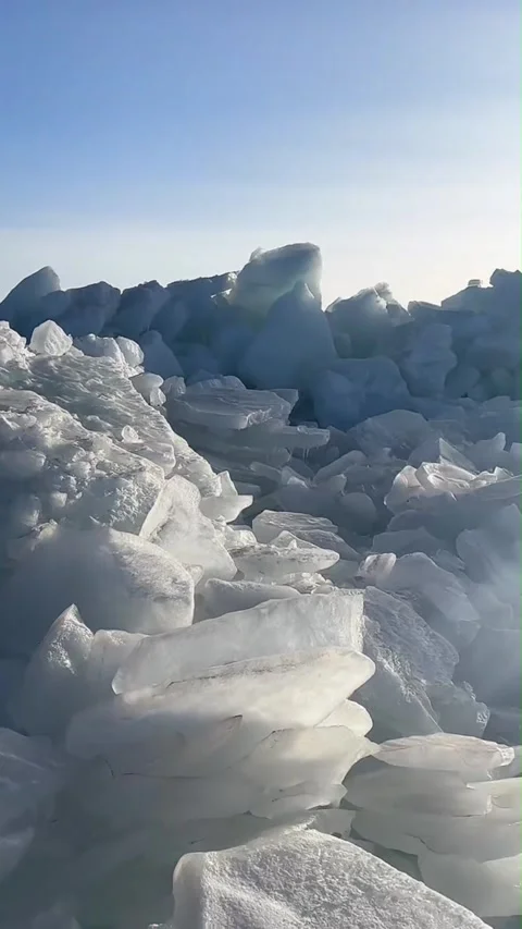Vertical Video of Handheld Walkthrough of Blue Ice Shards at Sayram Lake Video stock 328389645