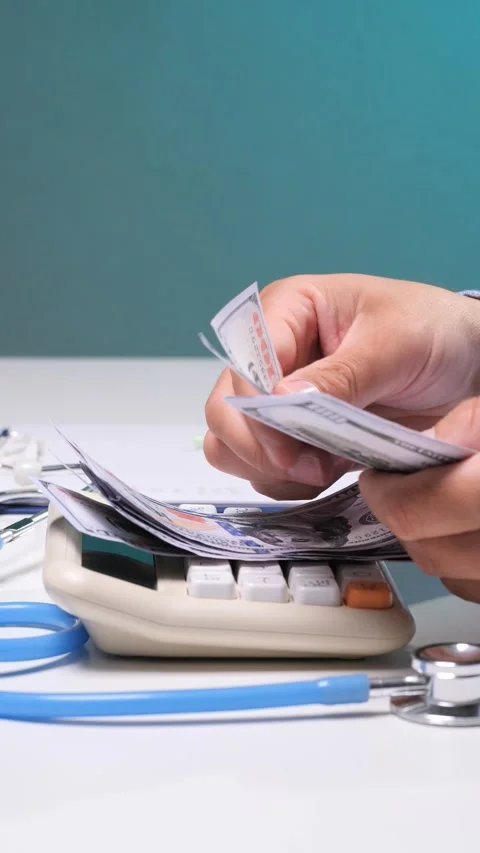 Vertical video hands are counting us dollar bills while resting on a Stock Footage 342770517