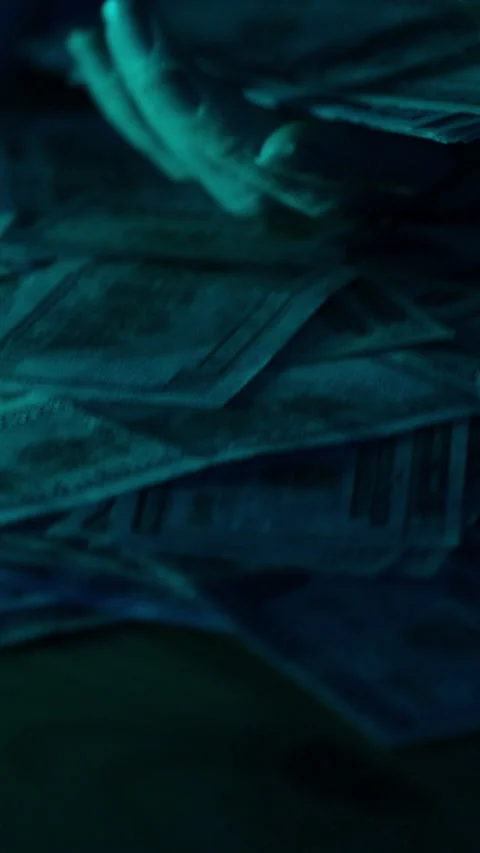 Vertical video. Hands count a stack of hundred-dollar bills over a table covered Stock Footage 296355218