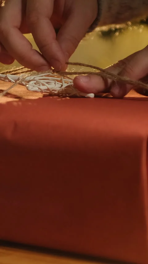Vertical video. Hands decorating box with Christmas present. Stock Footage 252943789
