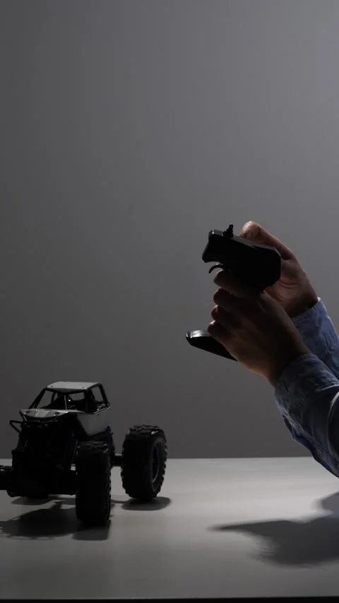 Vertical video hands holding a controller, operating a radio controlled monster Stock Footage 342668816