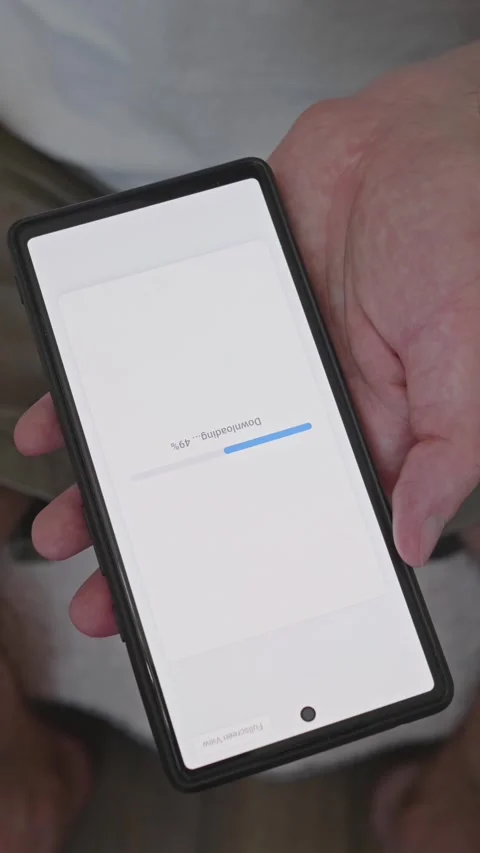 Vertical video, Hands holding mobile phone showing downloading progress status Stock Footage 341860732