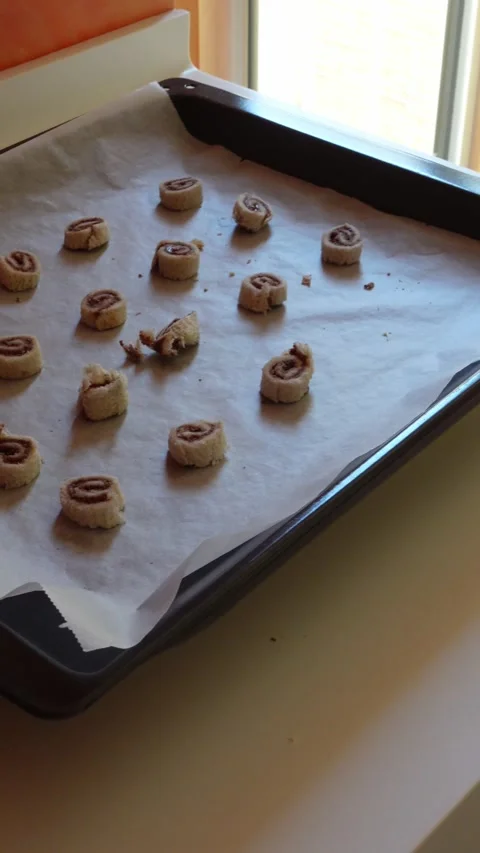 Vertical video of hands placing cinnamon rolls Stock Footage 292404933