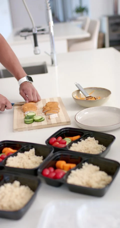 Vertical video: Hands placing cutting board, slicing protein and cucumber on Stock Footage 346718878