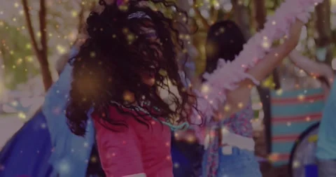 Vertical video: Hands raising, red shirt woman spinning, sparkles around, Stock Footage 331235139