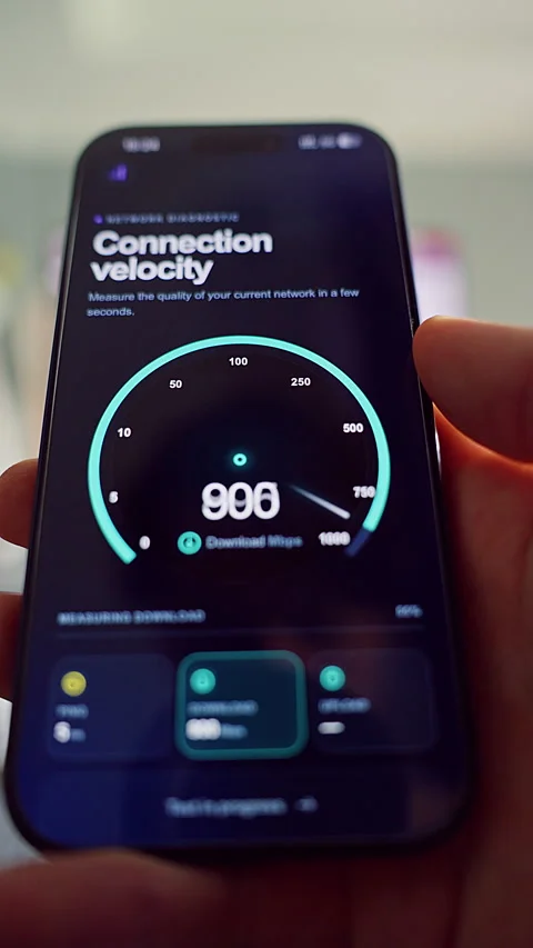 Vertical video. Hands Run an Internet Speed Test on a Mobile Phone, a Thumb Taps Stock Footage 348489172