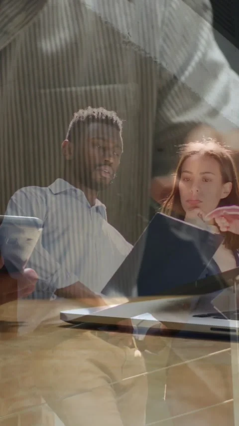 Vertical video: Hands tapping tablet starting huddle as team pointing reading 動画素材 330242596