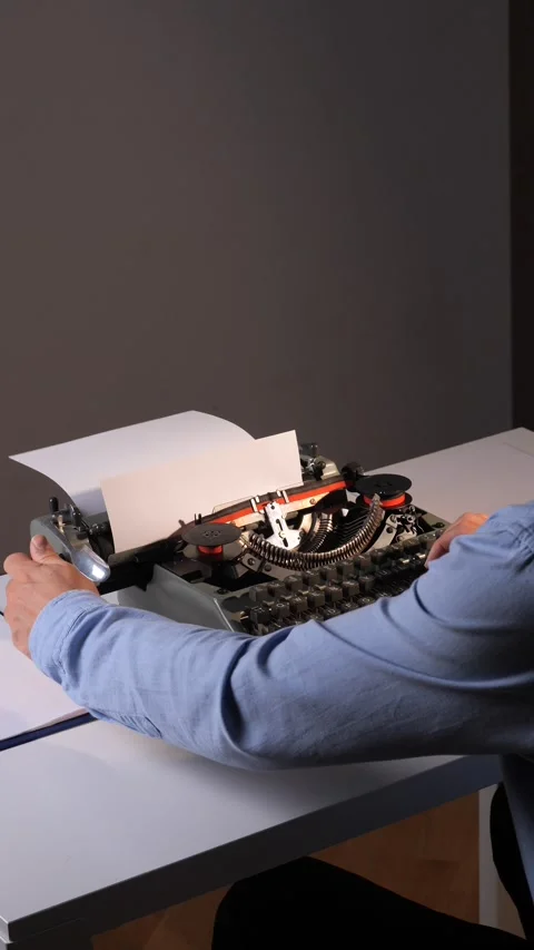 Vertical video Hands typing a document on an old vintage typewriter, composing Stock Footage 322167262