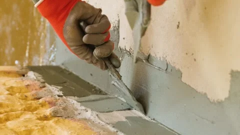 Vertical video. Hands use a spatula to putty the protrusion of the wall with the Stock Footage 267566490