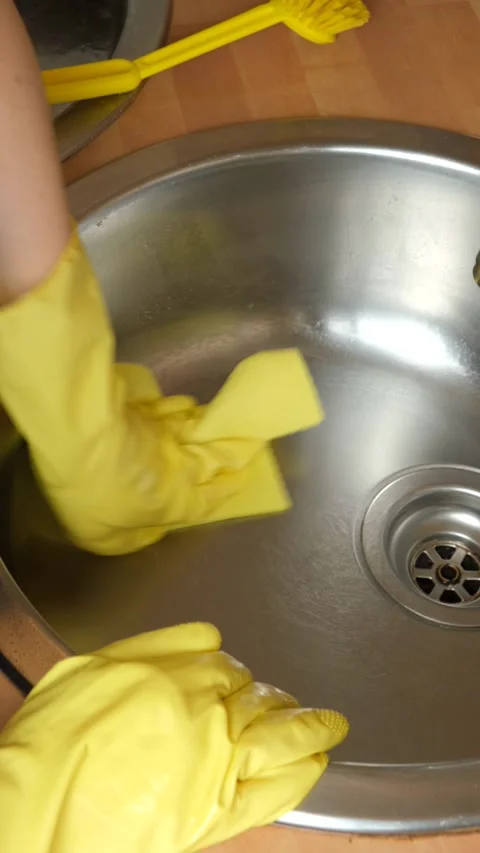 Vertical video of hands washing kitchen sink and rinsing cloth under faucet. Stock Footage 340167289