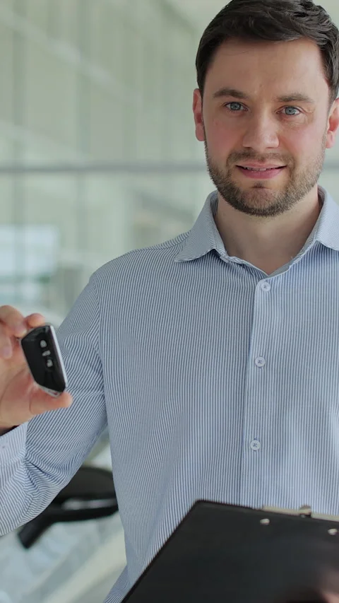 Vertical video Handsome man manager at a car dealership Stock Footage 337239479