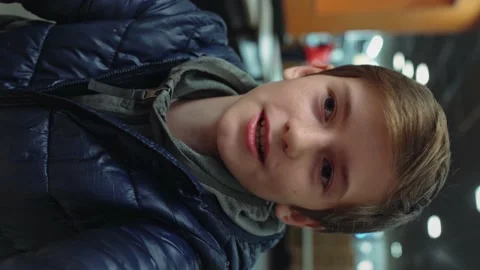 Vertical Video: Handsome Young Boy Talks During Conference Video Call in cafe Stock Footage 145419745