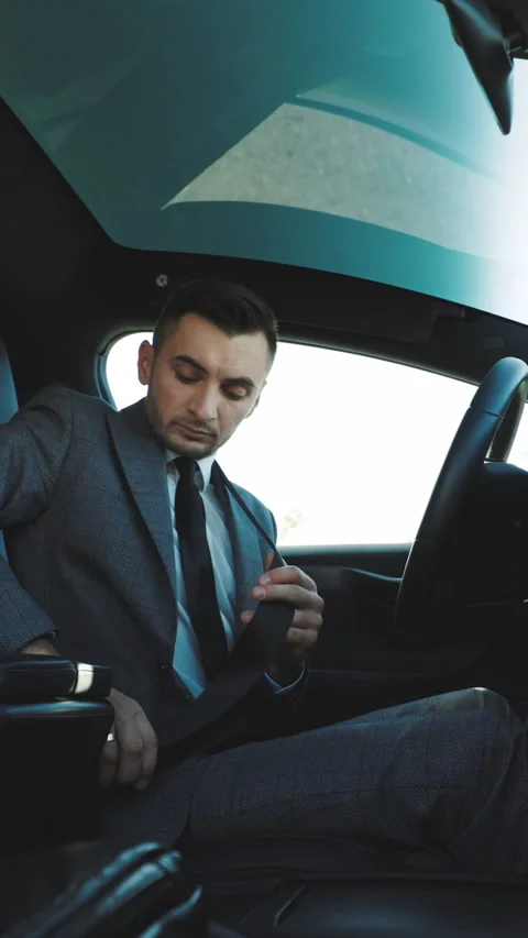 Vertical Video of Handsome young man pinches seat belt and riding happily Stock Footage 302649978