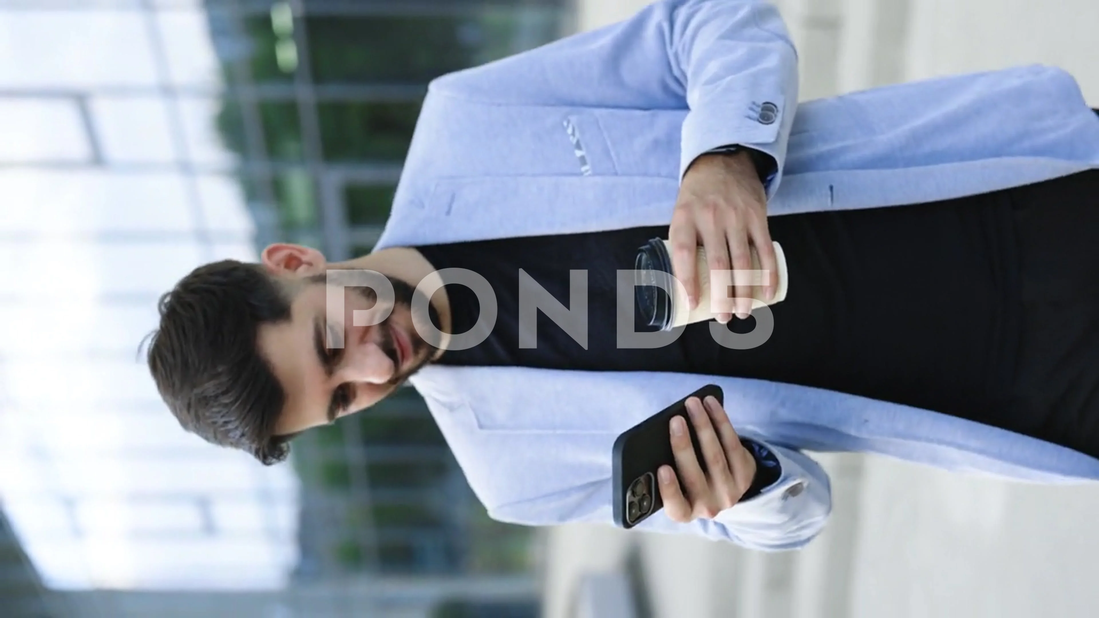 Vertical video of happy armenian young beard caucasian business man looking  at