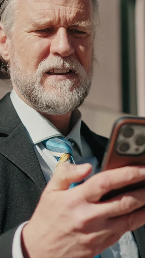 Vertical video, Happy Businessman Using Phone Outside Office Stock Footage 308809568