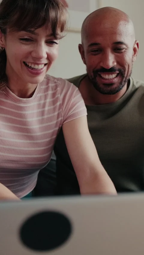 Vertical video, Happy Couple Browsing Laptop at Home Stock Footage 311318127