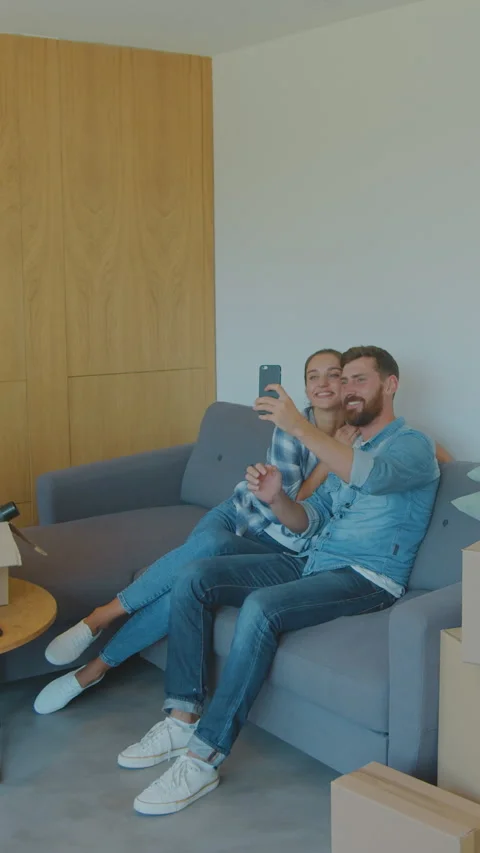 Vertical Video Happy couple taking a selfie with new home keys in slow motion. Stock Footage 337996182