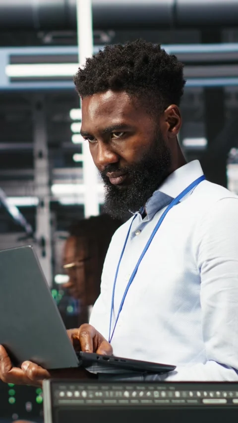 Vertical video Happy data center admin uses node tree programming on laptop Stock Footage 308752209