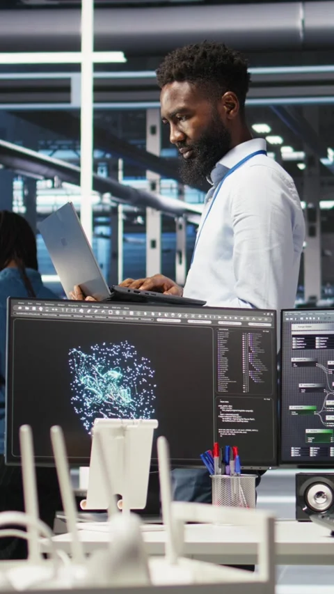 Vertical video Happy data center admin uses node tree programming on laptop Stock Footage 308752611