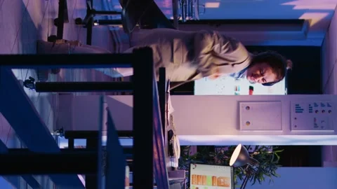 Vertical video: Happy employee analyzing graphs wearing headset Stock Footage 232985067
