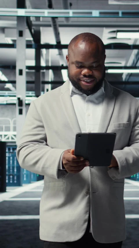 Vertical video Happy engineer walking in data center refining algorithms on Stock-Footage 311601086