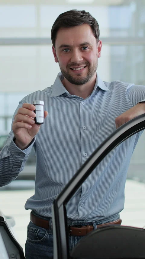 Vertical video Happy man standing at dealership near new car. Stock-Footage 337238223