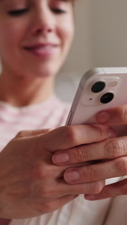 Vertical video, Happy Woman Using Phone on Sofa Stock Footage 306485468