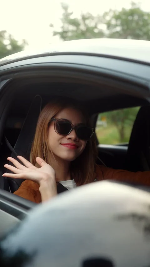 Vertical video. Happy young Asian woman sitting in her new car, smiling. Stock Footage 316747870
