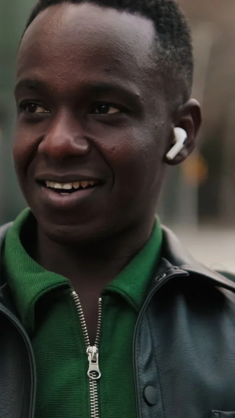 Vertical video, Happy Young Man Listening to Music on City Bench Stock Footage 326334554