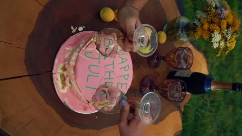 Vertical video. harry potter style birthday cake is cut with wine glasses. Stock Footage 201306441