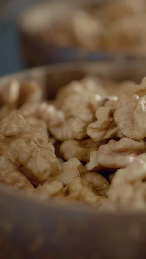 Vertical video Healthy walnut kernels in a bowl full of nutritious fats Stock Footage 329617532