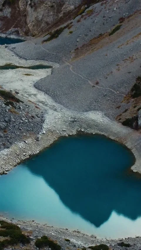 Vertical video: Heart Shaped Turquoise Lake in Rocky Mountain Valley Stock Footage 332010484