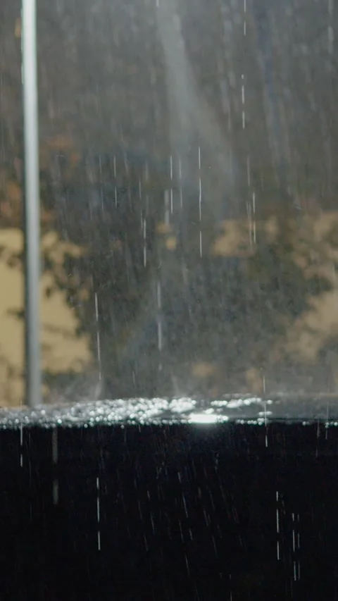 Vertical video Heavy rain and strong winds impact homes and cars during intense Stock Footage 323353797