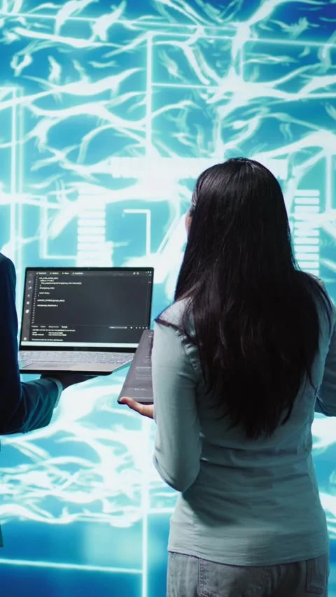 Vertical video High tech workspace colleagues using AI system, doing Stock Footage 278553876