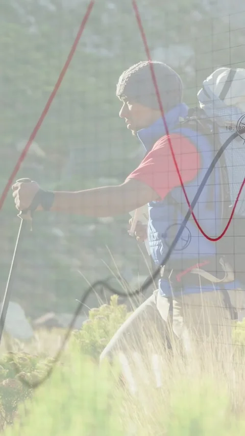Vertical video: Hiker reading map, using poles, climbing foothill, data overlay Stock Footage 333157657