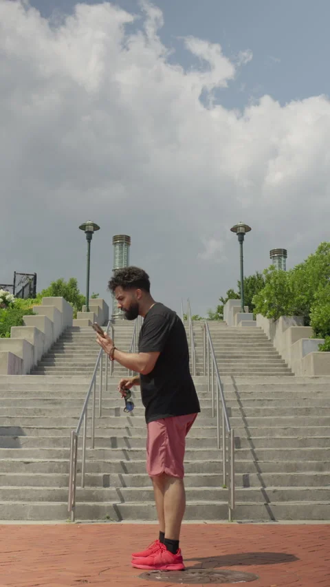 Vertical Video of a Hispanic Man Engaged in a Heated Phone Argument Stock Footage 246388309