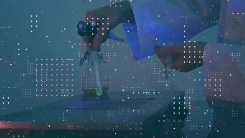 Vertical video: Holding clamp, tech lowering green vial onto scale to weigh in Stock Footage 332405122