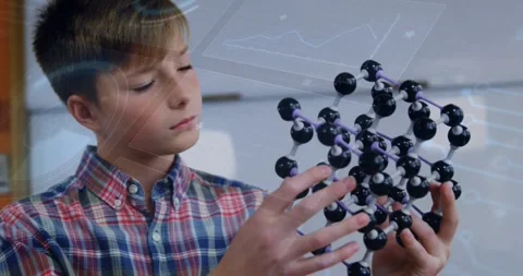 Vertical video: Holding molecular model, boy in plaid shirt rotating, studying Stock Footage 331169224