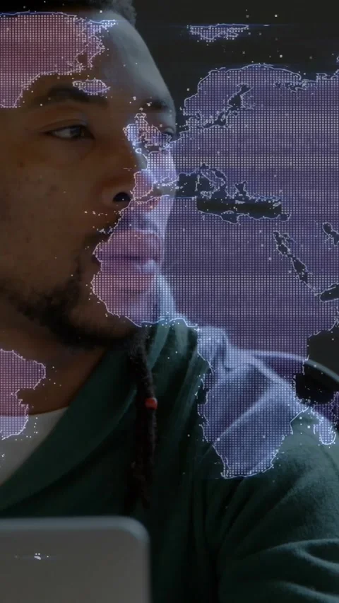 Vertical video: Hooded man speaking to laptop and turning head, dotted map Stock Footage 334604905