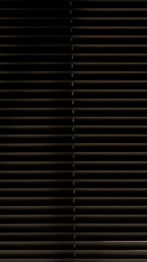 Vertical video. Horizontal Window Blinds Slowly Closing to Block Sunlight and Ou Stock Footage 339209564