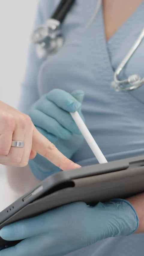 Vertical video in a hospital setting, two healthcare professionals are Stock Footage 277908153