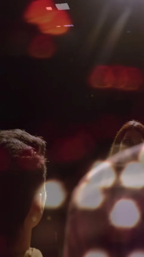Vertical video: Host entering light from right, talking to crowd in theater in Stock Footage 334602511
