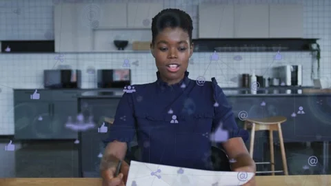 Vertical video: Host glancing paper reading gesturing social icons floating in Stock Footage 332405531
